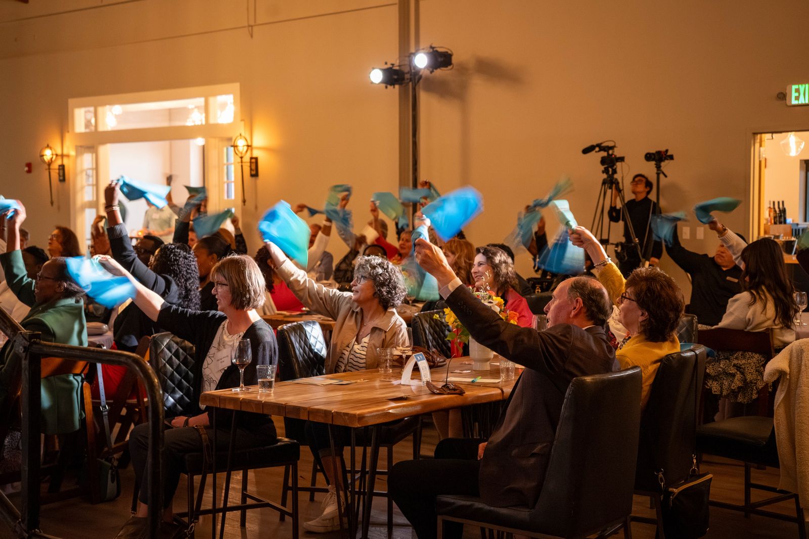 Guests raising paddles during the fund-a-need